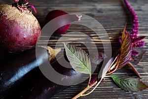 Purple vegetables on black wooden boards and amaranths