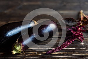 Purple vegetables on black wooden boards eggplants, amaranths twig