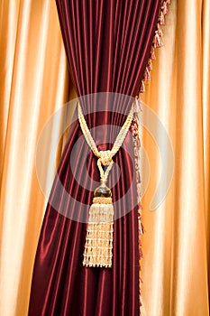 Purple velvet curtain with golden tassel
