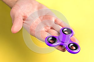 Purple and violet fidget spinner on hand