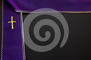 Purple violet priest`s stole on a black background