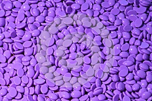 Purple wax granules. Abstract beautiful backdrop.