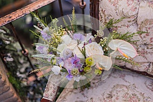 Purple and white bride bouquet standing on the chair photo