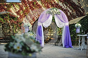 Purple white wedding arch otdoor photo