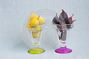 Purple and yellow tiger figs in crystal bowls