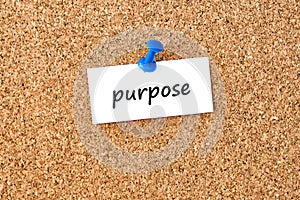 Purpose. Word written on a piece of paper, cork board background
