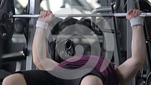 Purposeful fat man lifting barbell lying in gym, weight loss motivation, sport