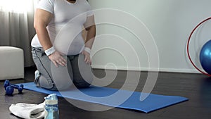 Purposeful overweight man going to do physical exercises, desire to lose weight