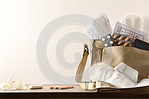 Purse with menstrual products on wooden table cloeup isolated background photo