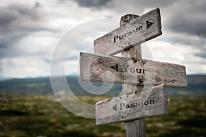 Pursue your passion text on wooden rustic signpost outdoors in nature/mountain scenery. photo