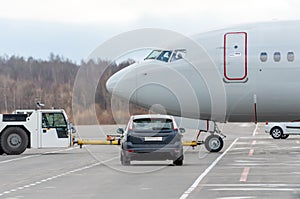 Push back tow tractor aircraft. Airfield services in the car waiting to miss the plane at the intersection