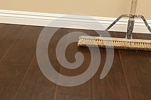 Push Broom on a Newly Installed Laminate Floor and Baseboard