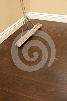 Push Broom on a Newly Installed Laminate Floor and Baseboard photo