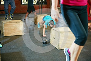 Push harder, get stronger. Shot of a young woman doing push ups during her workout at the gym.