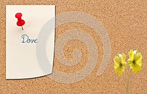 Push pin with paper note on cork billboard