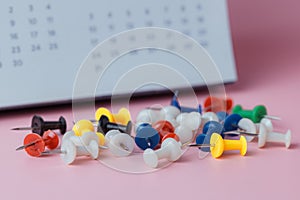 Push pins with blurred calendar