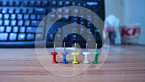 Push pins isolated on a wooden background