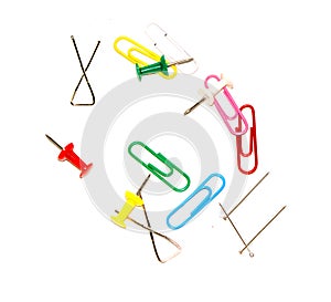 Push pins and paper clips in different colors isolated on white background.