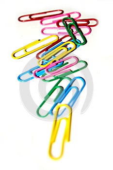 Push pins and paper clips in different colors isolated on white background.