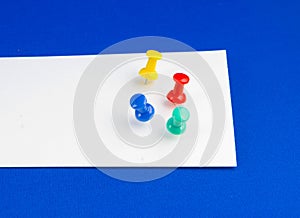 Push pins on white paper.