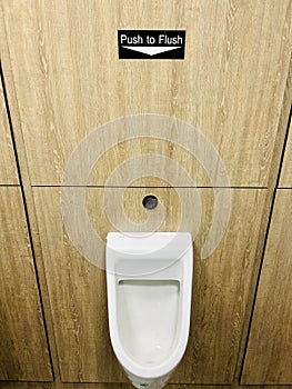 Push to Flush urinals in men's toilets for water saving and efficiency