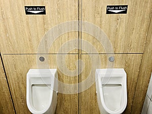 Push to Flush urinals in men's toilets for water saving and efficiency
