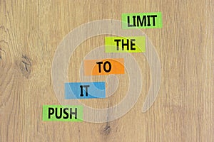 Push it to the limit symbol. Concept words Push it to the limit on colored paper. Beautiful wooden table wooden background.