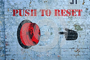 Push to reset world graffiti on grungy wall, the great reset concept