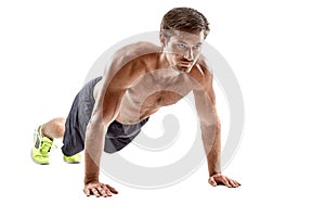 Push up fitness man doing push-up bodyweight exercise on gym floor. Athlete working out chest muscles strength training