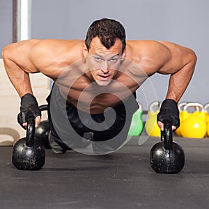 Push up on kettlebells fitness training