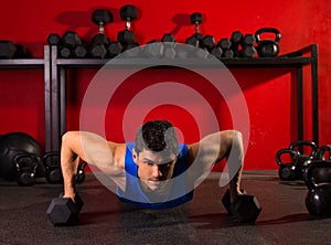 Push-up strength man hex dumbbells workout at gym