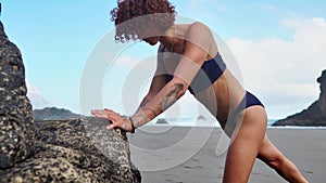 Push-ups fitness woman doing pushups outside on beach working out. Fit female sport model girl training crossfit
