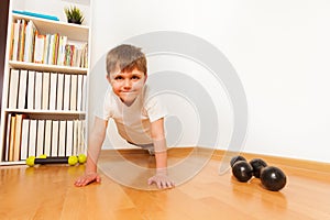 Push-ups or press-ups exercise by preschooler boy