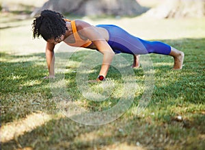 Push yourself to do better. a sporty young woman doing push ups as part of her exercise routine.