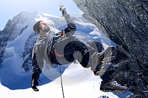 Push yourself to the top. Shot of a mountaineer hanging from a rope on a rockface.