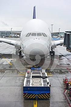 Pushback tug and a large airplane at an airport