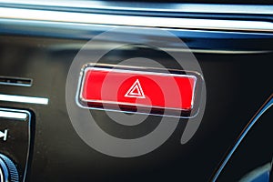 Pushed red warning button with triangle pictogram and flasher li