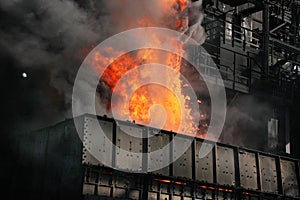 Pushing hot coke from coke oven on large steelworks.