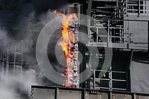 Pushing hot coke from coke oven on large steelworks.