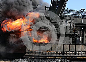 Pushing hot coke from coke oven on large steelworks.