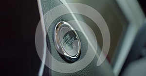 Pushing power ignition button to start keyless ignition hybrid car engine.