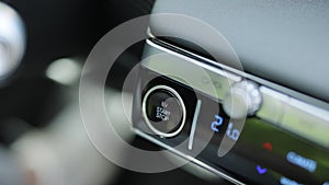 Pushing start stop Button to start keyless ignition hybrid car electro engine. Starting car engine. Button to start the