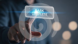 Man's hand pushing mark complete button on virtual interface