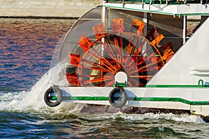 The pushing wheel of an old river ship is in motion.