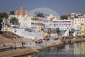 Pushkar ghats and lake during bathing and rituals on a sunny day, Pushkar, Rajasthan, India