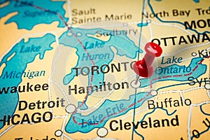 Pushpin pointing at Hamilton city in Ontario, Canada