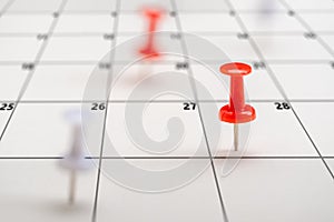 Pushpins on calendar. Business management event, business plan targeted marketing activities. Embroidered pins on calendar event.