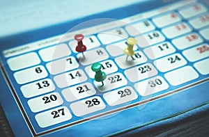 Pushpins on calendar. Concept of important day