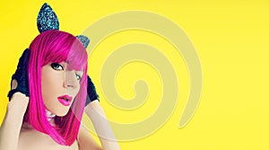 Pussycat lady in bright wig on yellow background