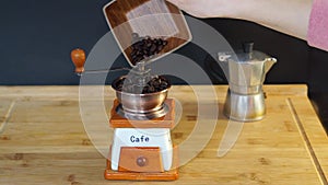 Put coffee beans into the manual coffee grinder